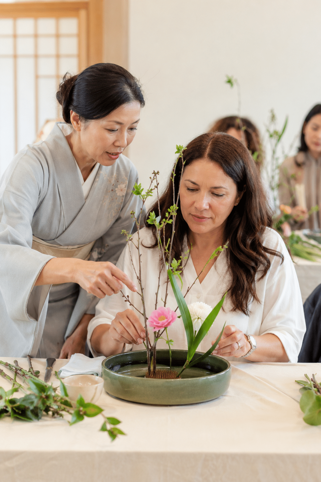 A participant creating an Ikebana flower arrangement